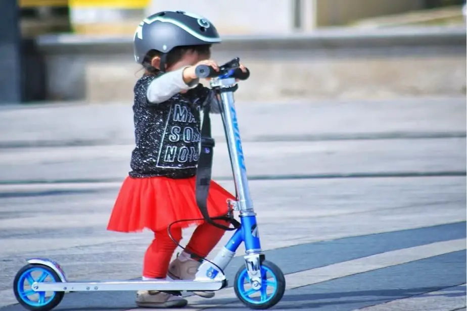 Toddler riding kick scooter