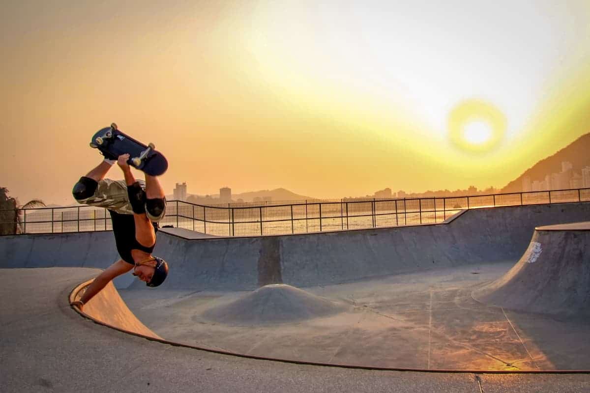 Upside down skateboarder at sunset