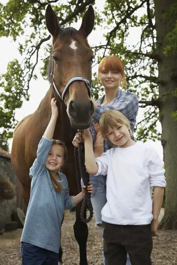 Woman and 2 girls with horse