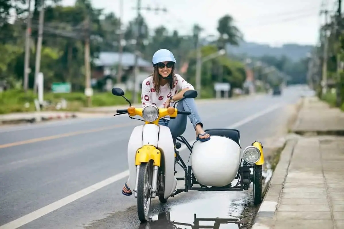 Woman on motorcycle with sidecar