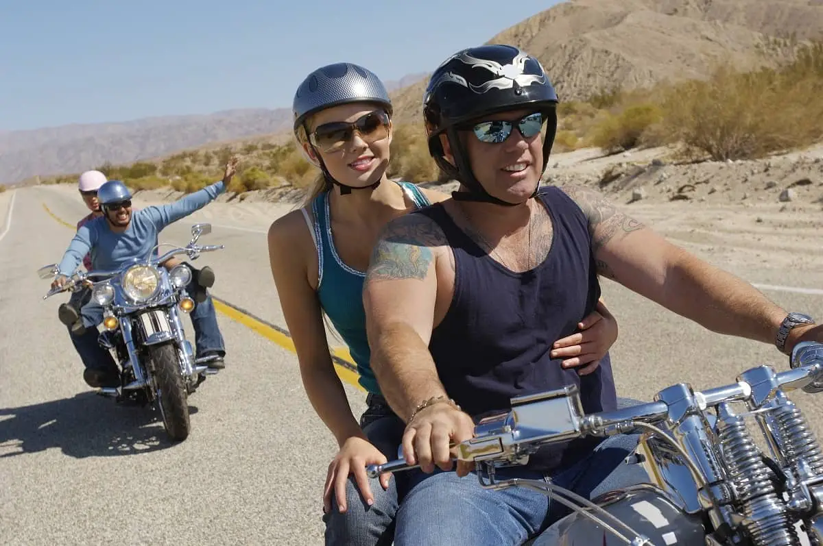 Are bicycle helmets DOT approved? Two couples riding motorcycles on the open road. Her helmet looks like a bicycle helmet.