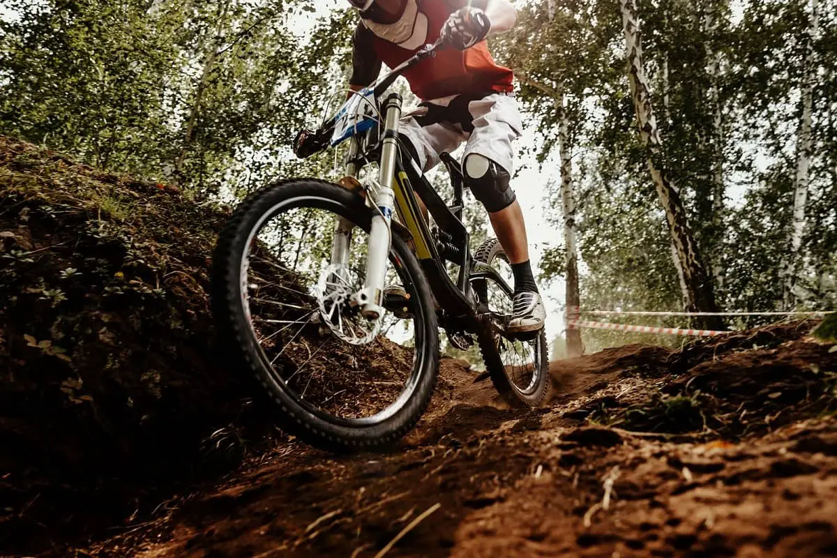 Mountain bike going down dirt track