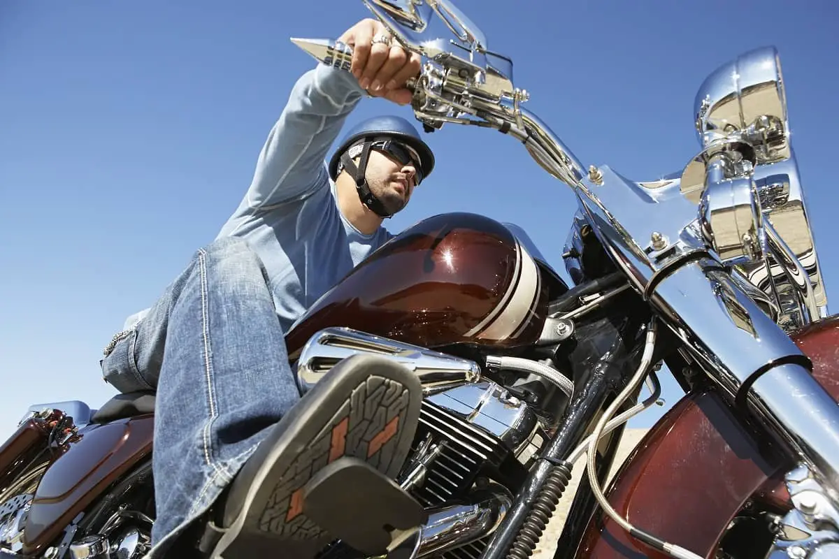 So many different types of motorcycle helmet available. This man has chosen a half shell helmet.