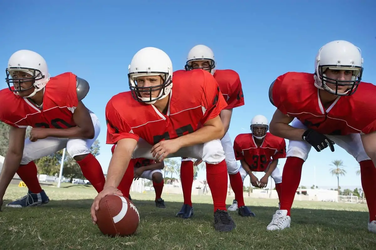 Stickers on College Football Helmets 2 Offensive line ready to hike football on field