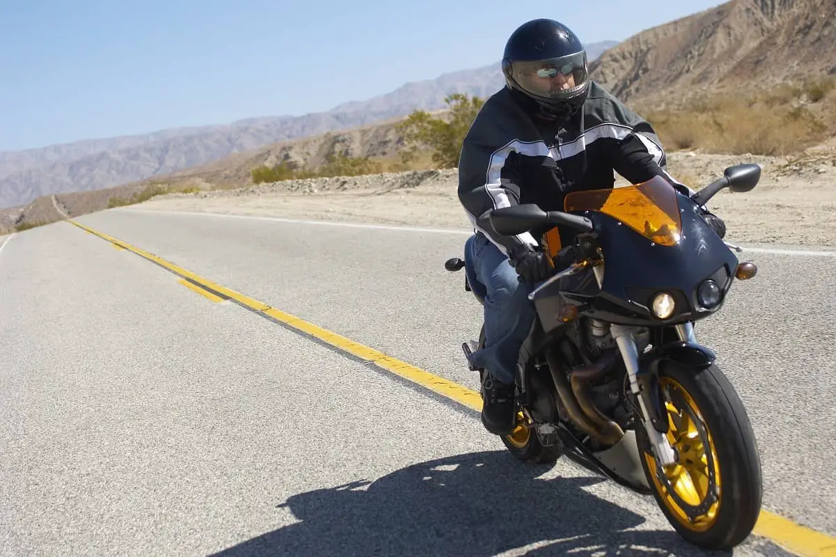 Motorcyclist on open highway in desert