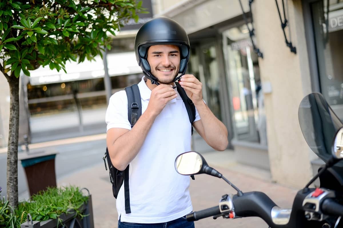 Man putting on motorcycle helmet