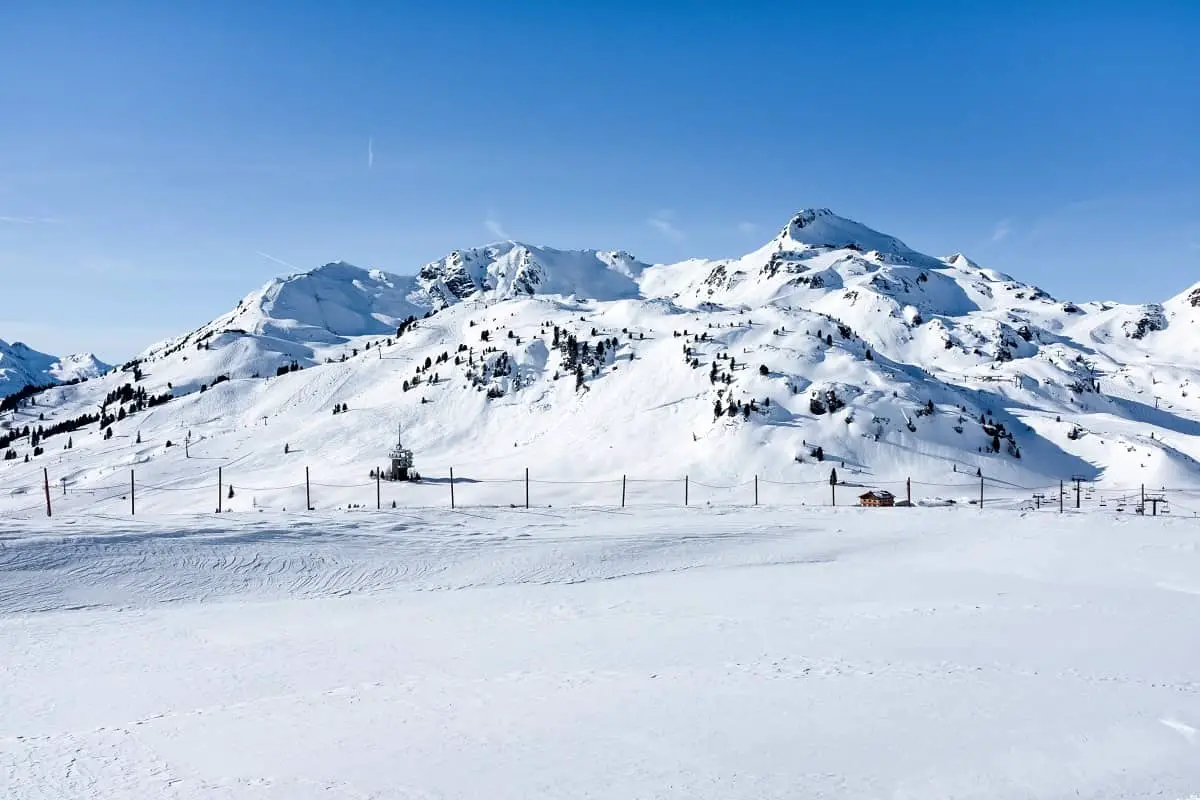 Snow fields with small snow covered hills behind