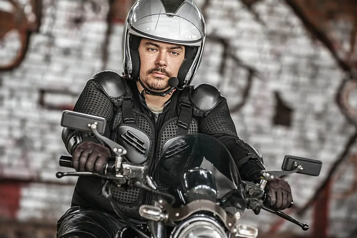 Motorcyclist wearting helmet with audio microphone attached