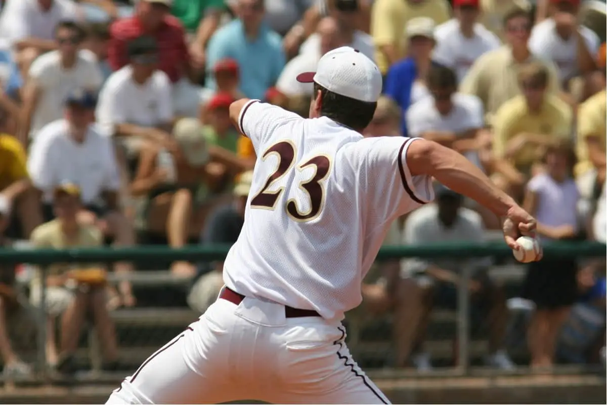 Baseball pitcher wearing number 23 about to pitch the ball