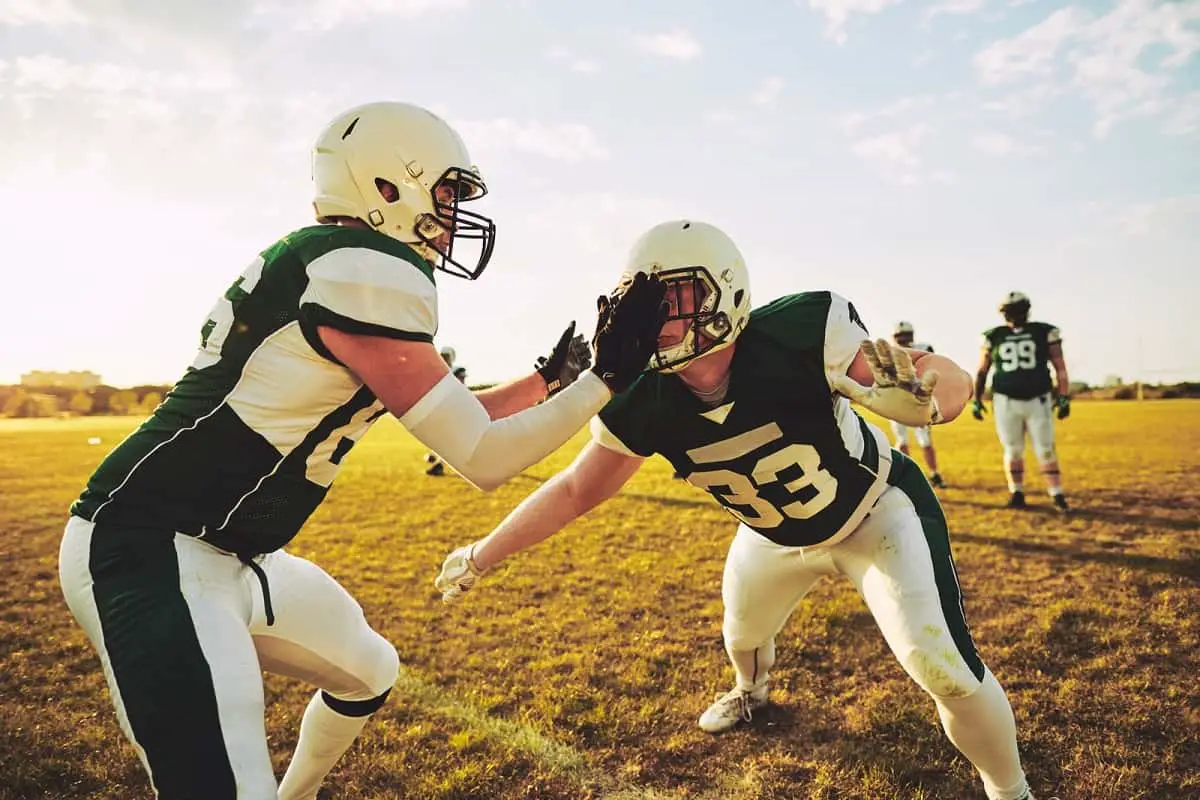 American footballers practicing tackling