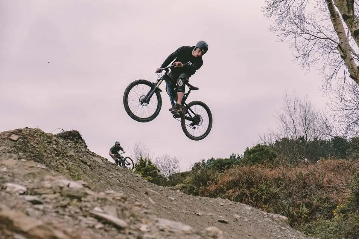 mountain biker in the air on rocky terrain