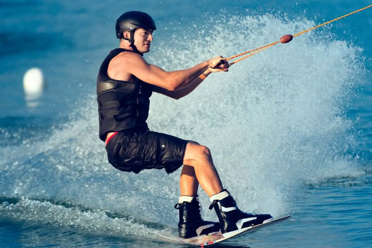 man wakeboarding wearing black helmet