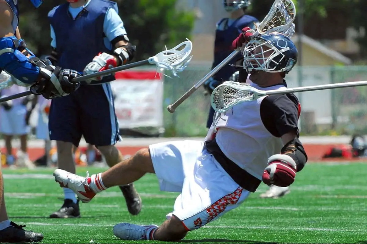 lacrosse player falling down backwards