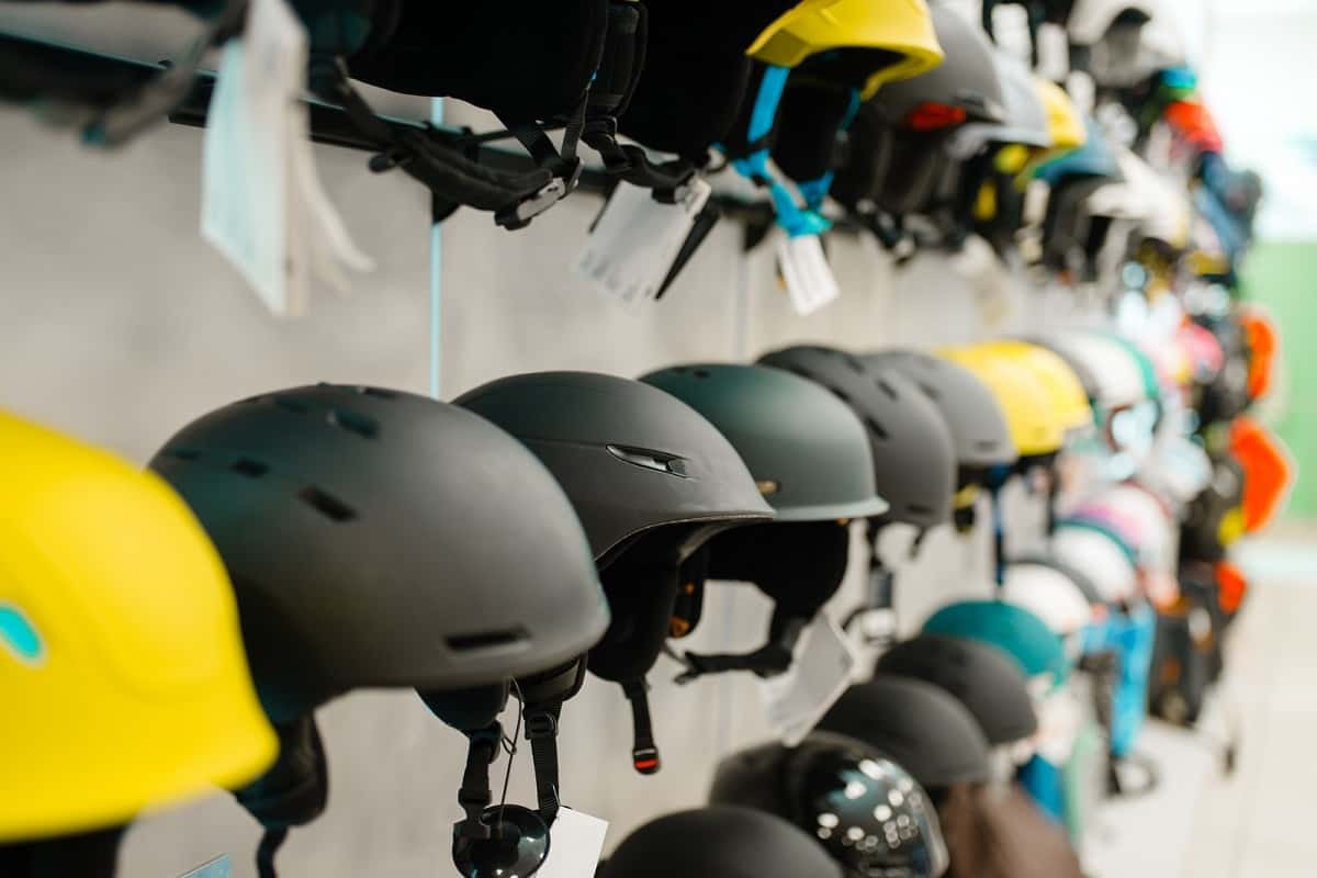 rows of ski helmets on display in a store