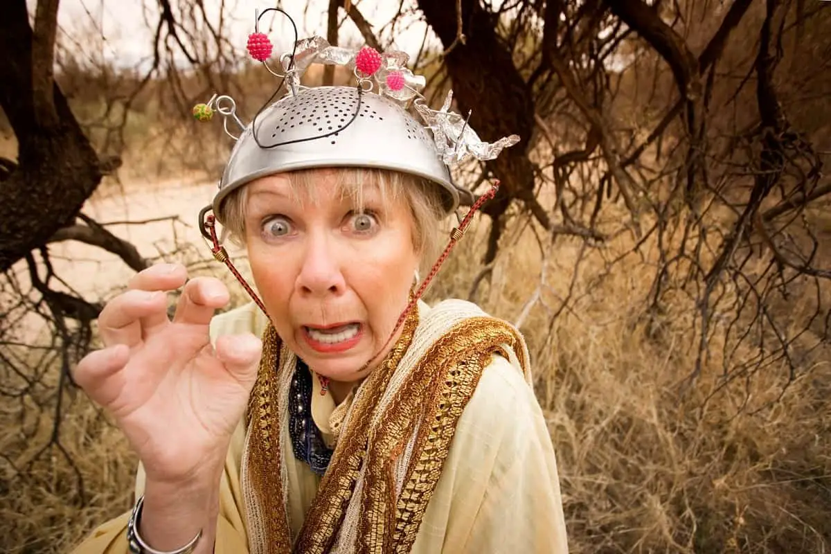 crazy looking woman wearing a colander on her head