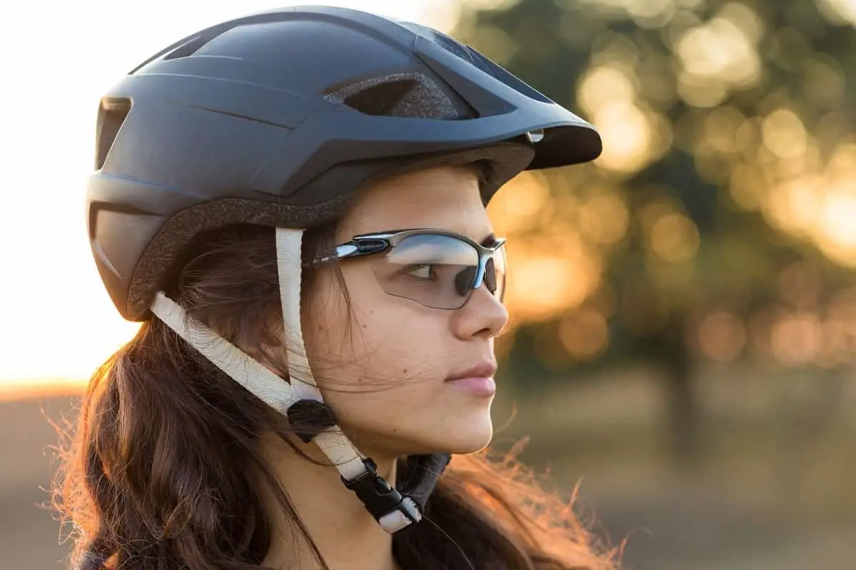 woman wearing black mtb helmet and sunglasses