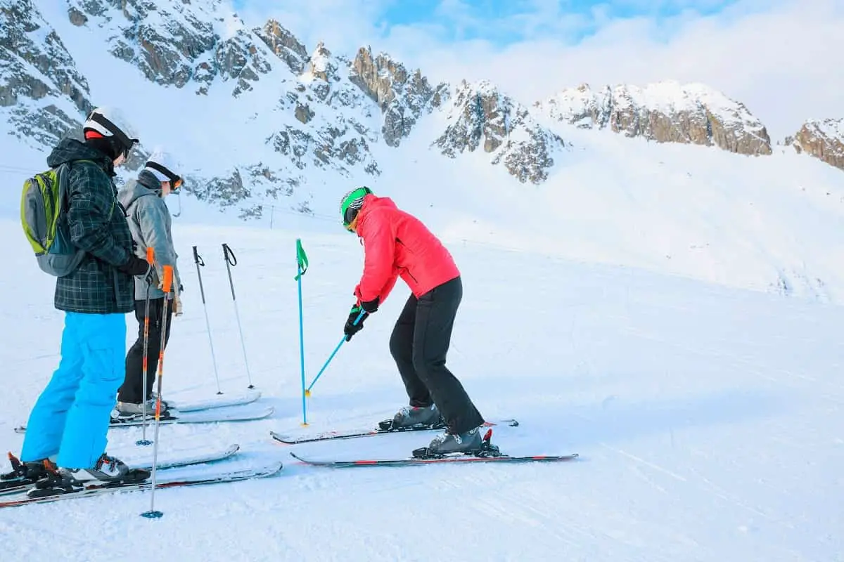 ski instructor with two young snow skiing students