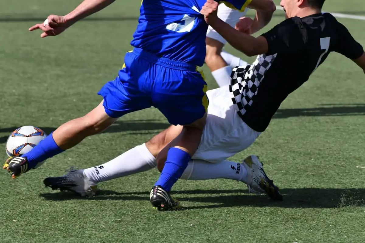 Should Protective Headgear Be Mandatory In Soccer 2 soccer players tackling while going for the ball