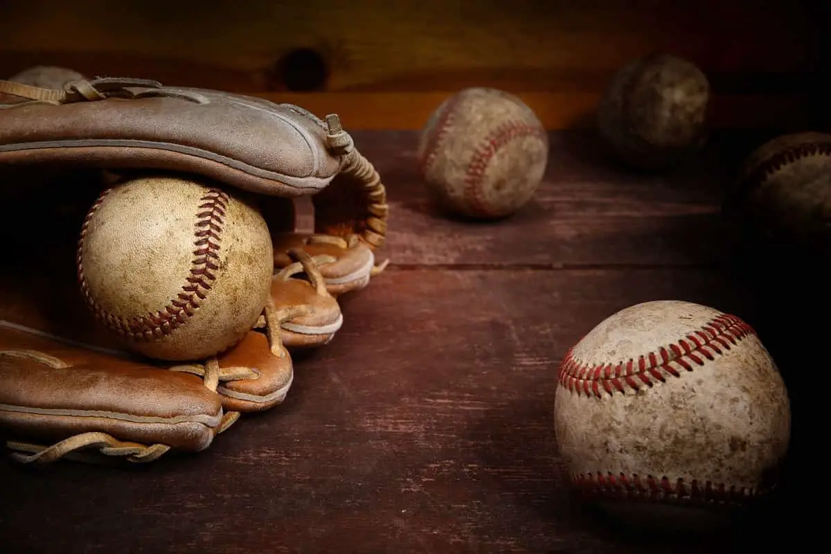old baseball mitt and dirty old baseballs