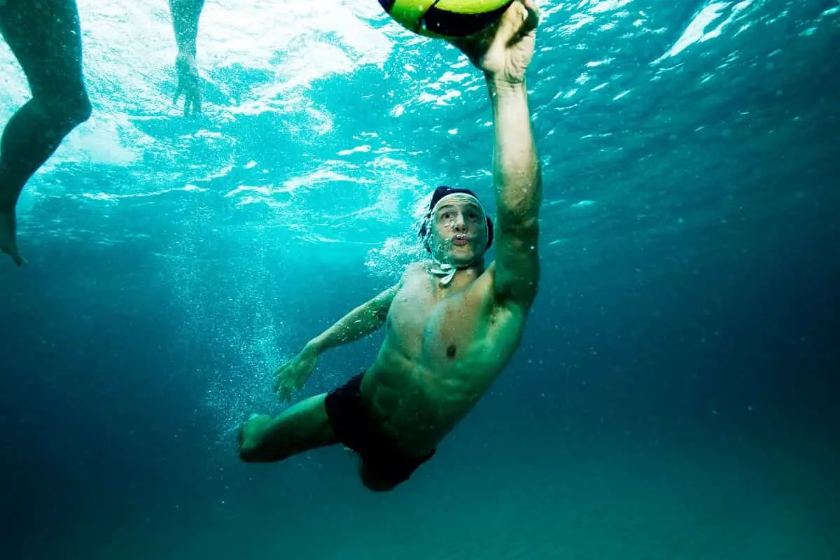 underwater shot of water polo player going for the ball