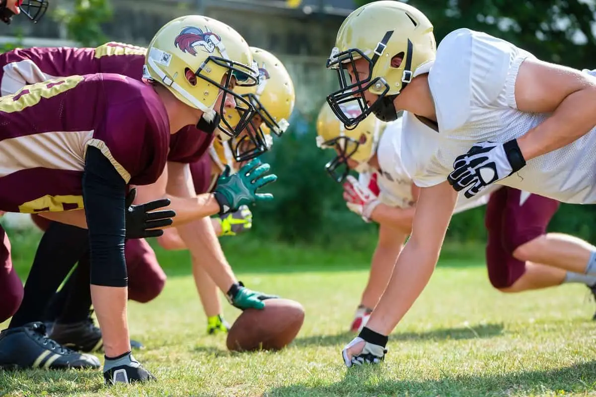 two opposing football teams ready to start game of football