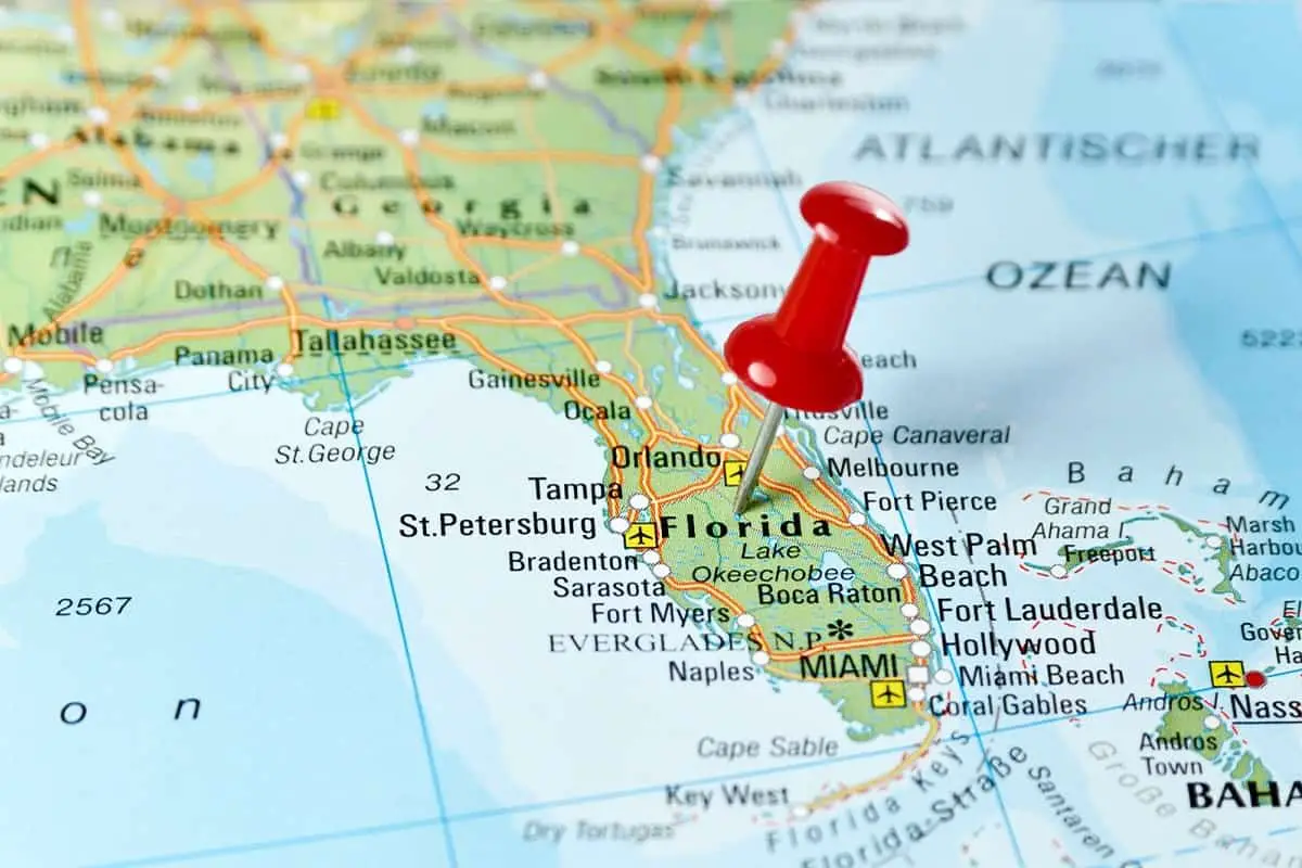 map of florida with red pin stuck in it