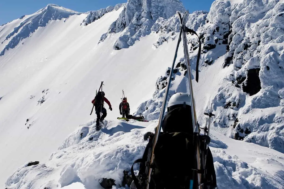 Can you use a climbing helmet for skiing.  These 3 mountaineers walking along snow-capped mountain carrying skis and wearing helmets would love to know.