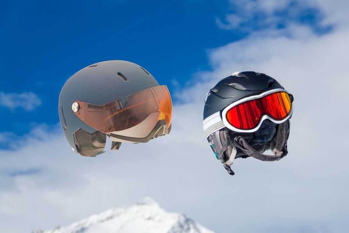 One visor ski helmet and one regular ski helmet with goggles floating in the sky.