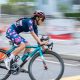 woman in bicycle race wearing red bike helmet