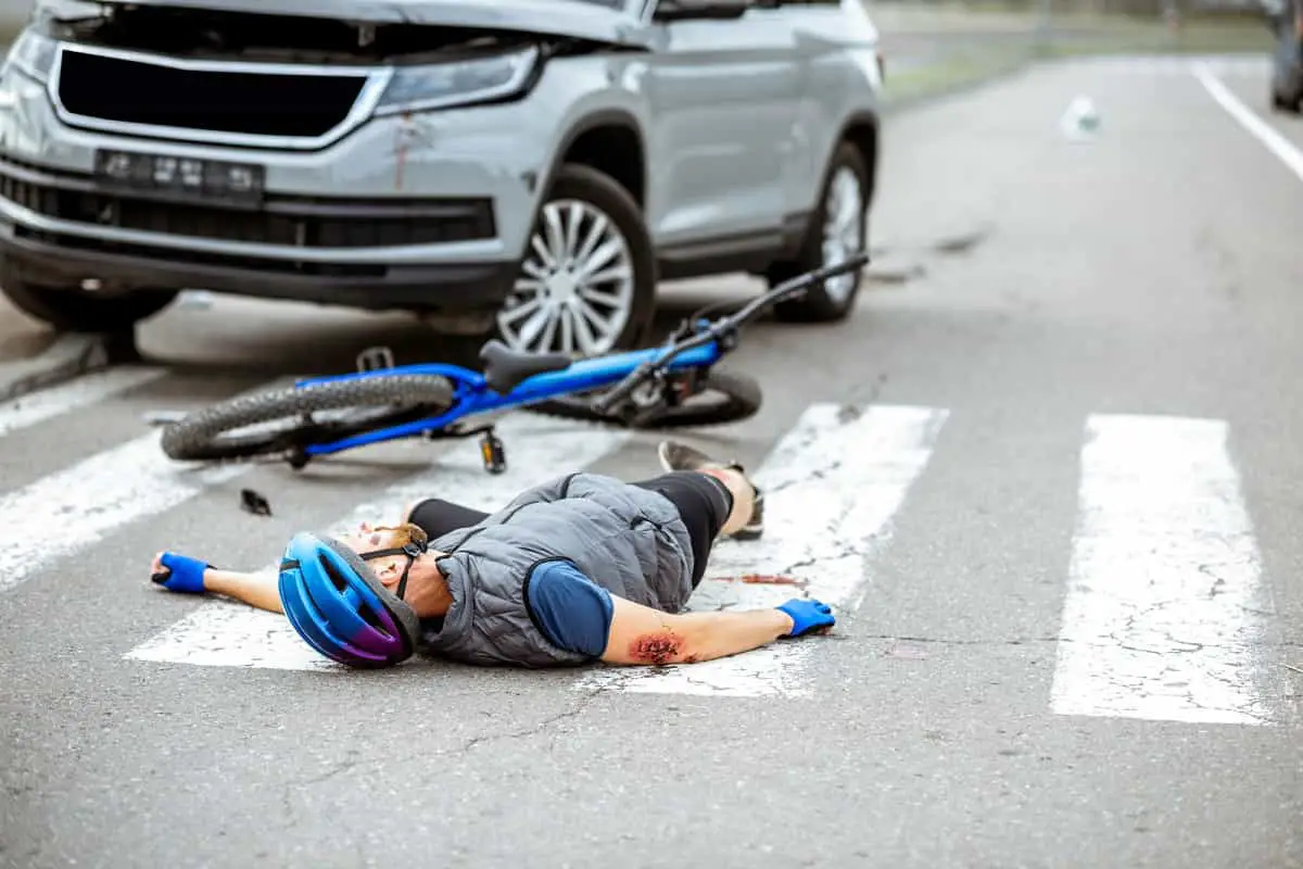 traffic accident between car and bicycle with cyclist unconscious on the road