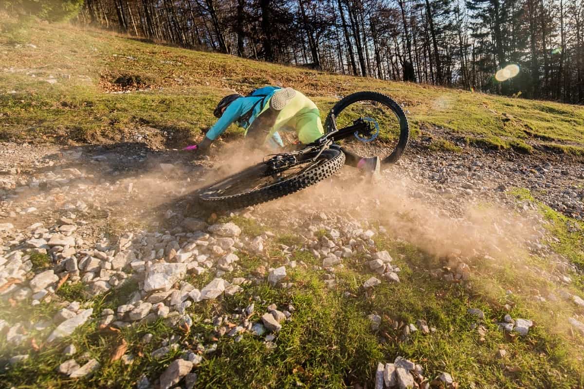 Mountain biker slides on gravel and crashes