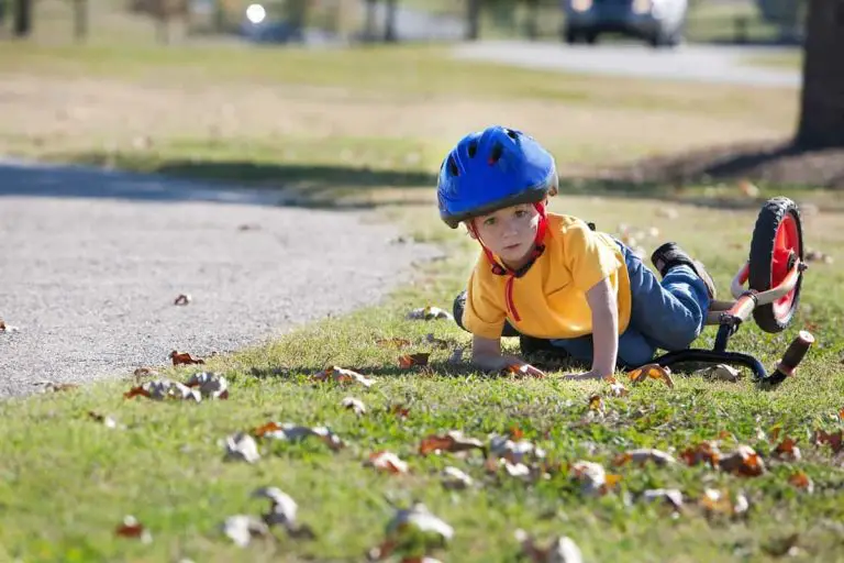 Young boy takes a fall from his bicycle