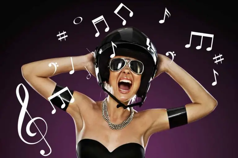 Woman wearing a motorcycle helmet listening to music.