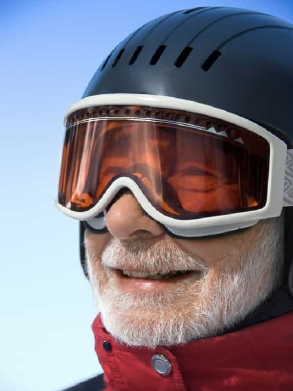 Man wearing a ski helmet with ski goggles.