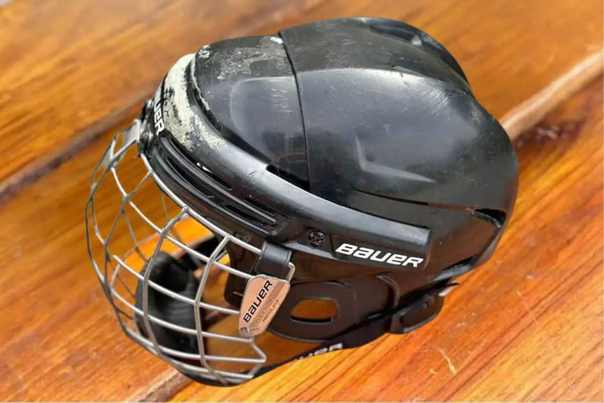 An old Bauer hockey helmet with a fair bit of damage. A prime example in anyone's quest to know how long are hockey helmets good for.