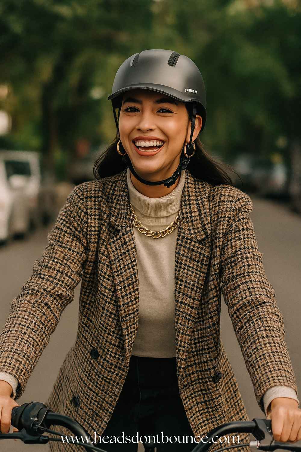 Close-up of a well-dressed business woman wearing a Shinmax baseball-style bike helmet as she cycles down a tree-lined street on her way to work.