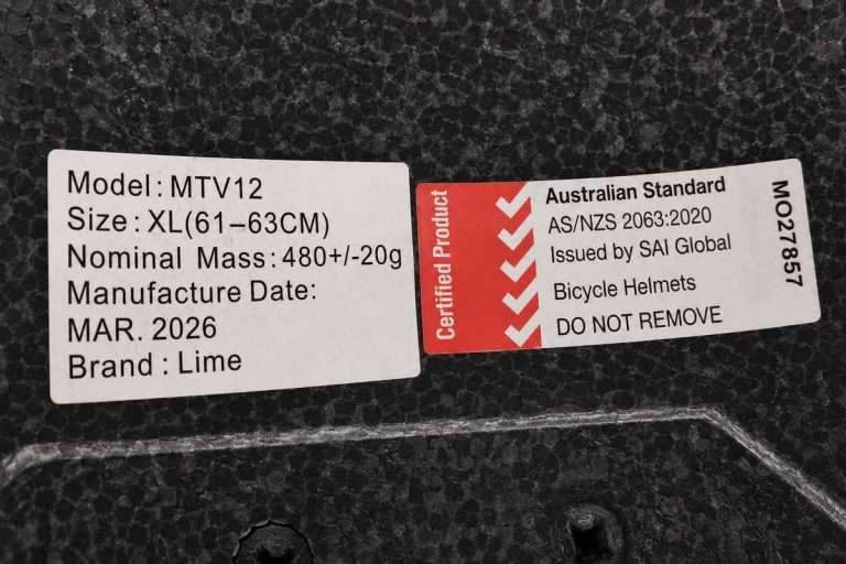 Bicycle helmet interior labels showing model information, March 2026 manufacture date, and AS/NZS 2063:2020 Australian bicycle helmet certification.