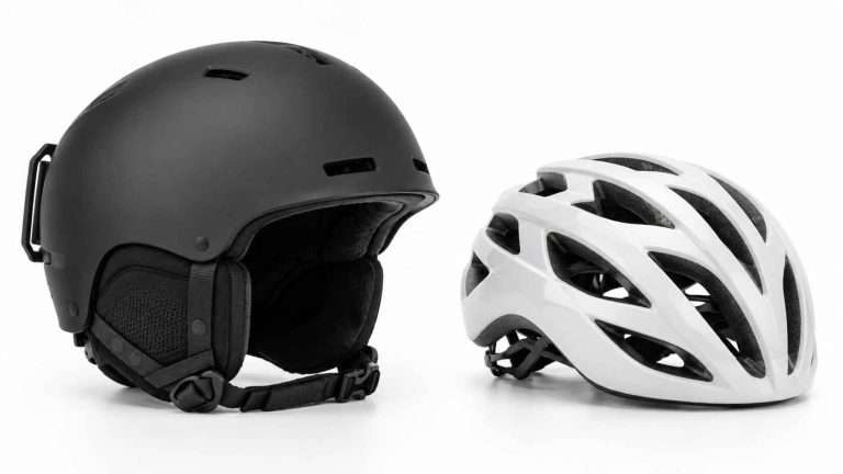 Black ski helmet and white bicycle helmet shown side by side for comparison.